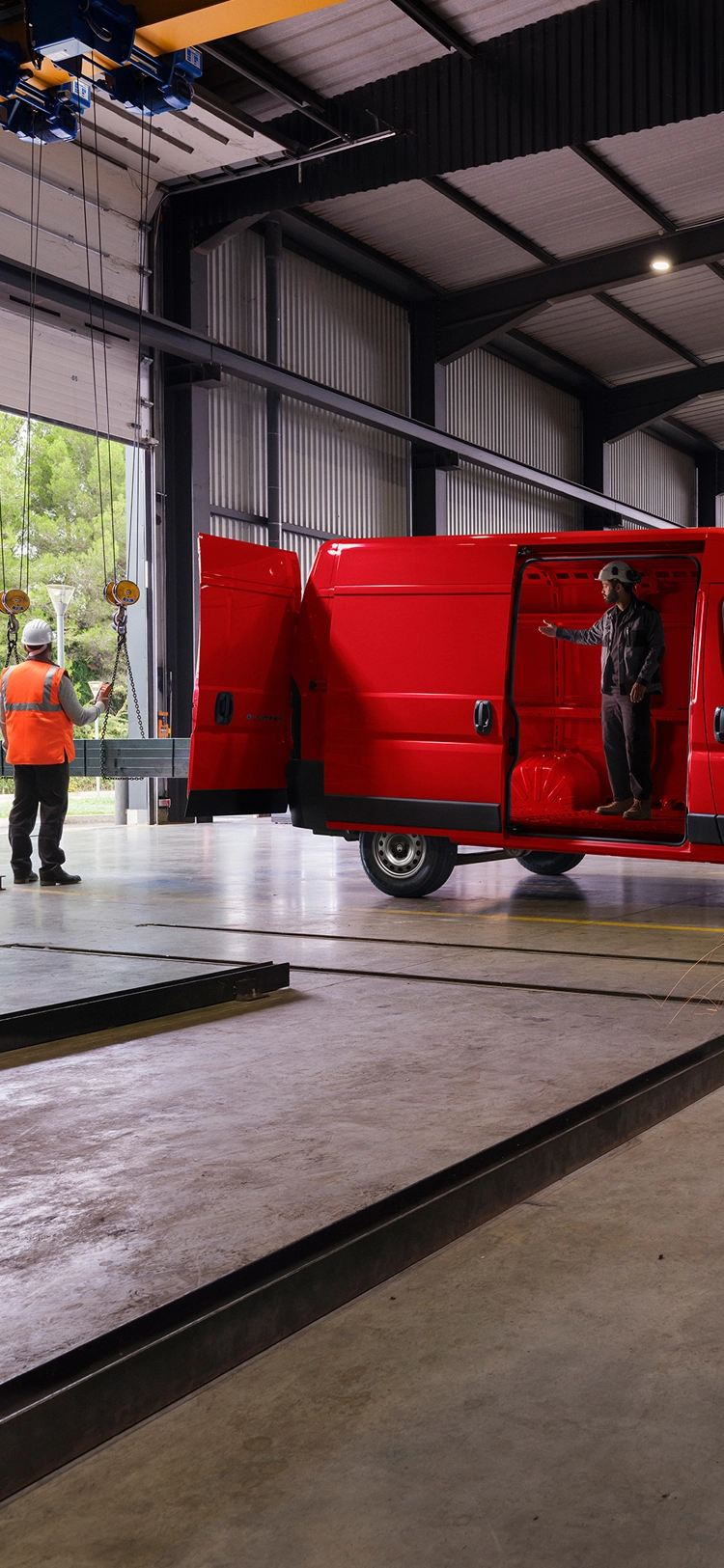 Vista laterale di Citroën Jumper rossa in un ambiente di officina, che mette in risalto il design esterno robusto e l'utilizzabilità professionale.