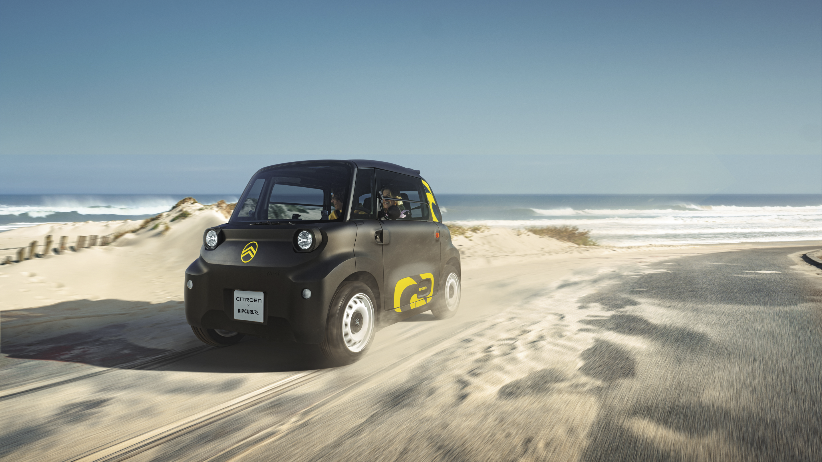Vista frontale tre quarti in azione Citroën Ami x Rip Curl elettrica senza patente, Citroën Ami libertà per mobilità urbana elettrica