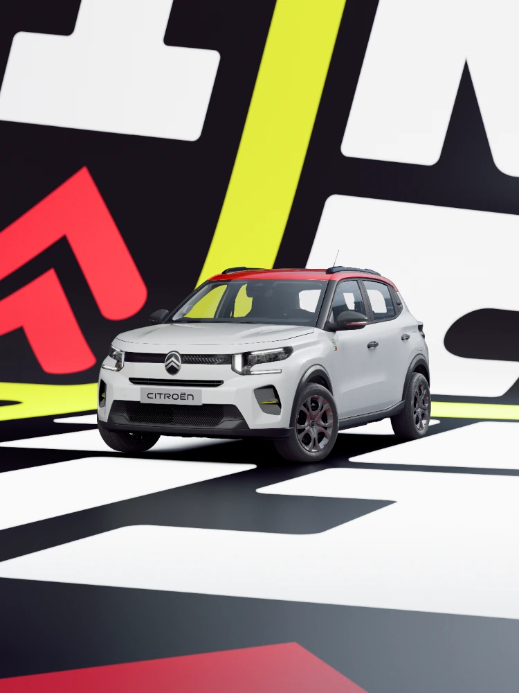 Vista anteriore a tre quarti di Citroën ë-C3 TONIC, edizione speciale della city car elettrica, con assetto dinamico e contesto grafico dal forte impatto visivo.